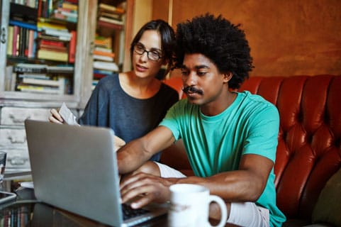 A couple looking online for information on personal loans.